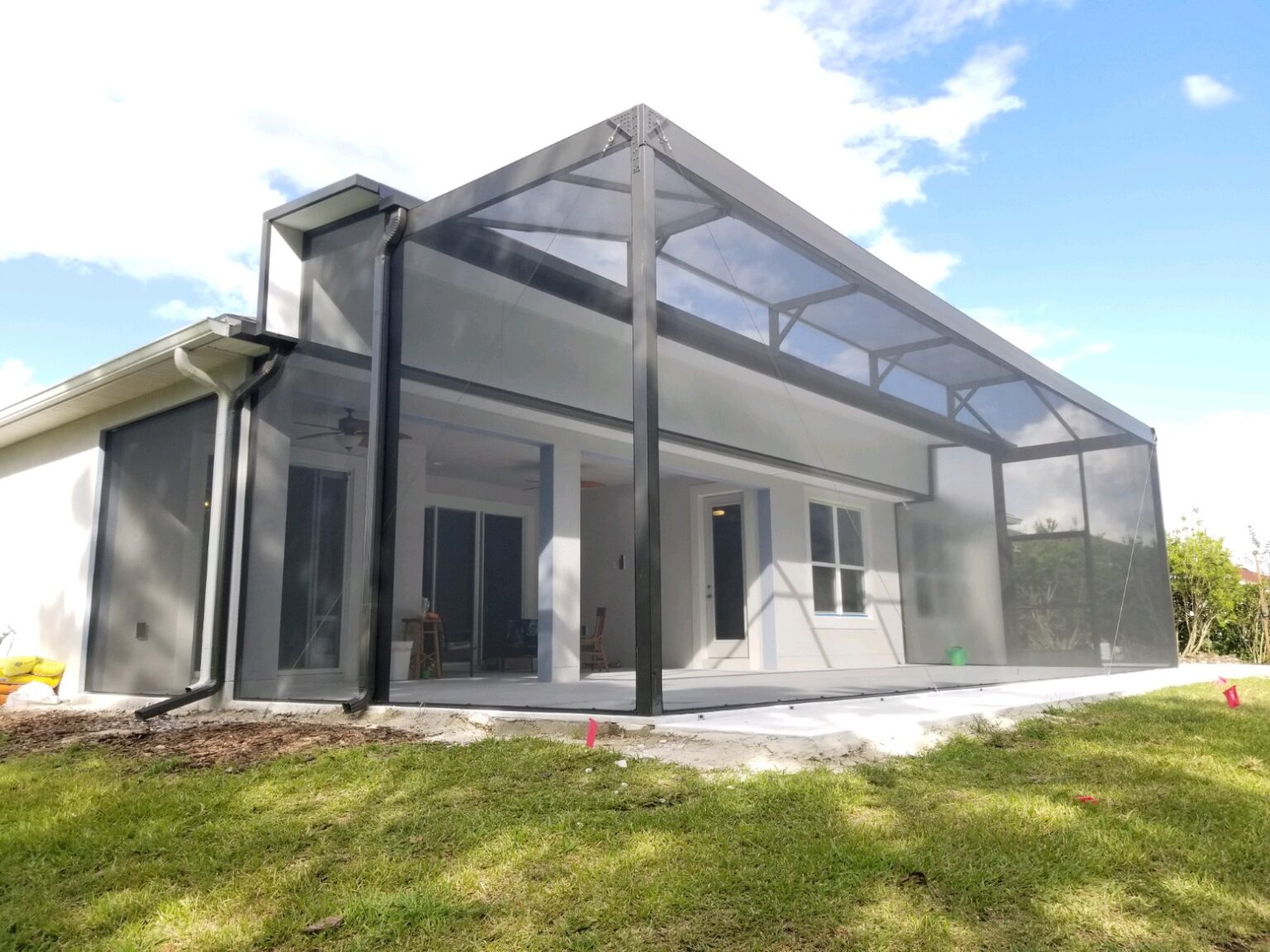 A large house with a big porch and lots of windows.